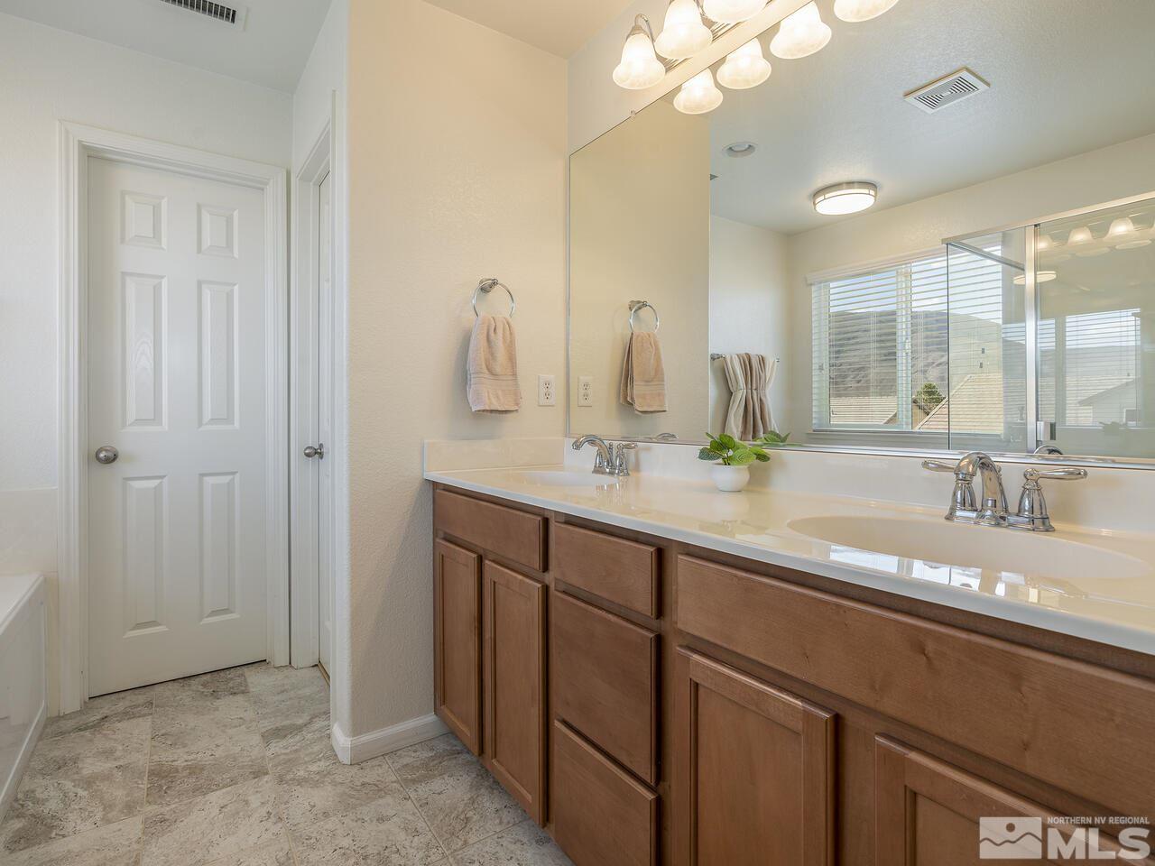 2055 Peaceful Valley Drive Reno, NV 89521 - Photo 13 of 26 a bathroom with a double vanity sink and a mirror
