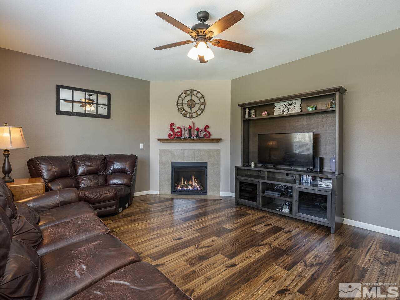2055 Peaceful Valley Drive Reno, NV 89521 - Photo 7 of 26 a living room with furniture a flat screen tv and a fireplace