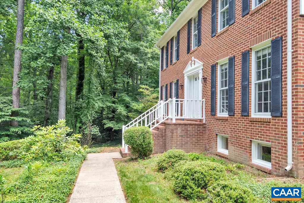 105 Terrell Road East Charlottesville, VA 22901 - Photo 4 of 37 a front view of a house with a yard and trees