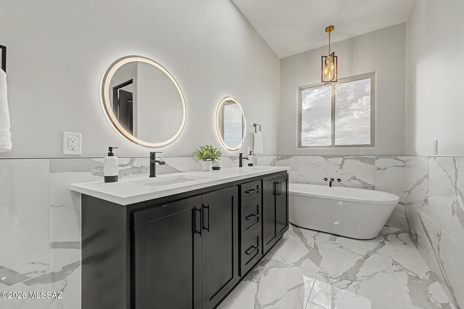 2399 Della Roccia Court Tucson, AZ 85737 - Photo 19 of 34 a bathroom with a sink and a mirror