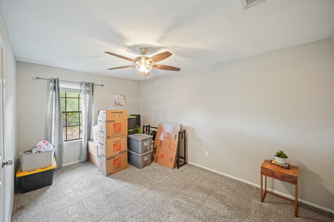 15831 Ridge Park Drive Houston, TX 77095 - Photo 12 of 26 This room features neutral walls, carpeted flooring, and a ceiling fan. A window allows natural light, and there's ample space for storage or furniture.