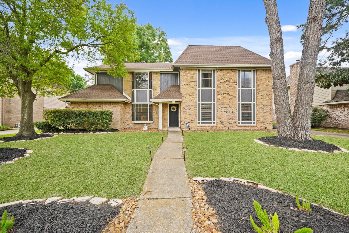 15831 Ridge Park Drive Houston, TX 77095 - Photo 2 of 26 This charming two-story brick home features a well-maintained front yard with mature trees and a welcoming walkway. The large windows and classic design offer great curb appeal in a serene neighborhood setting.