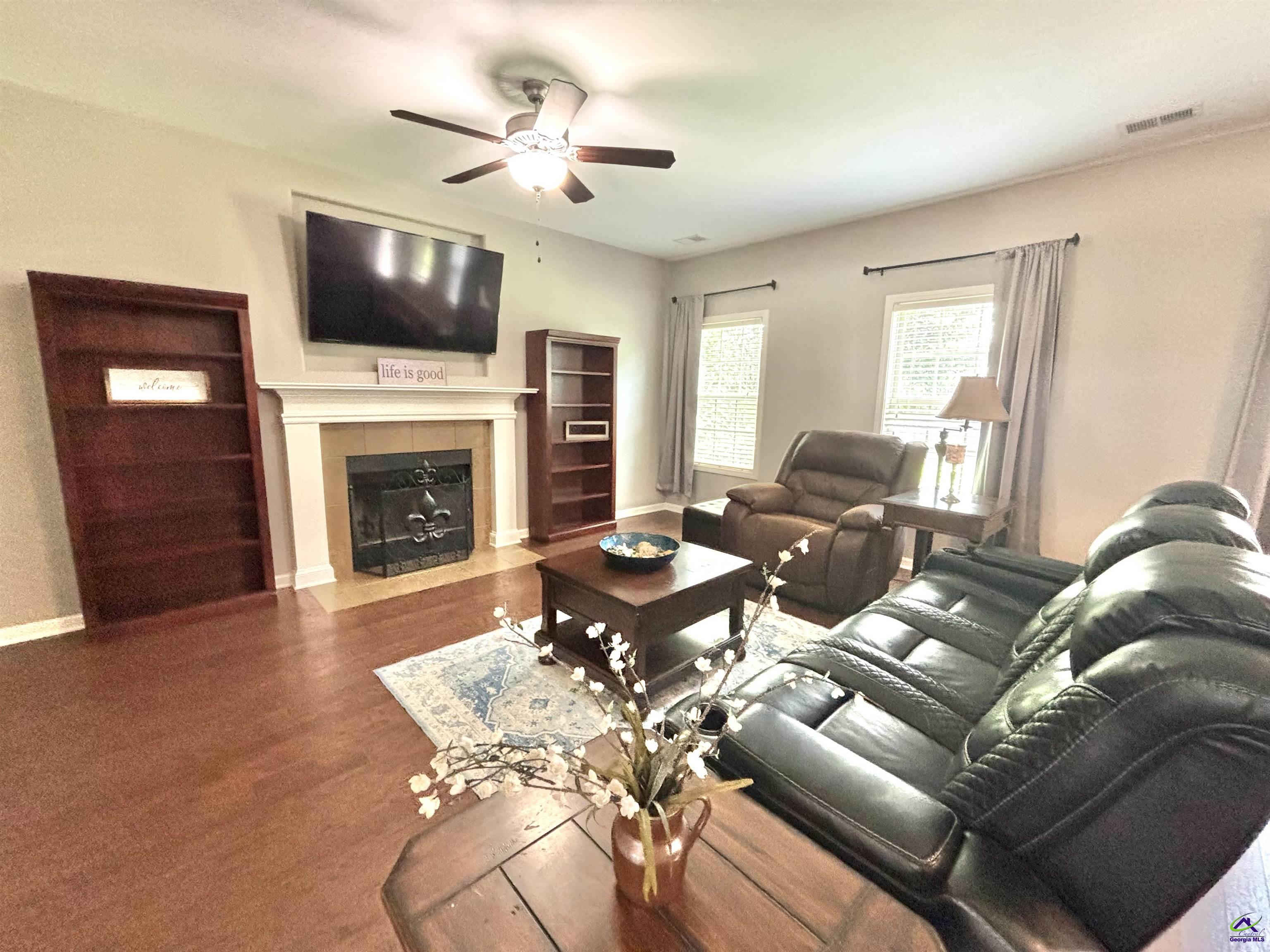 600 Post Oak Way Warner Robins, GA 31088 - Photo 13 of 50 a living room with furniture a fireplace and a flat screen tv