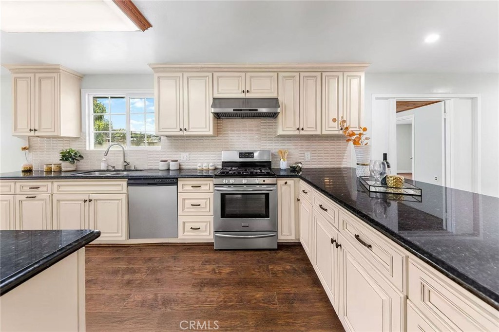 511 Dalesford Drive La Puente, CA 91744 - Photo 13 of 37 a kitchen with granite countertop white cabinets and white appliances