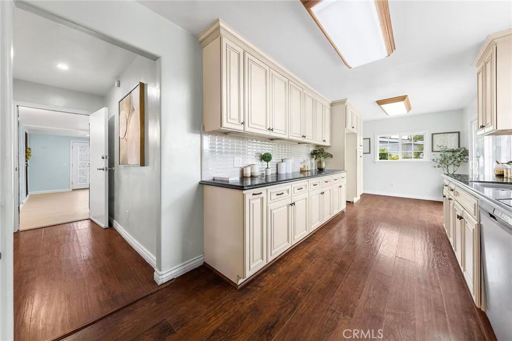 511 Dalesford Drive La Puente, CA 91744 - Photo 14 of 37 a kitchen with granite countertop a refrigerator a sink dishwasher and white cabinets with wooden floor