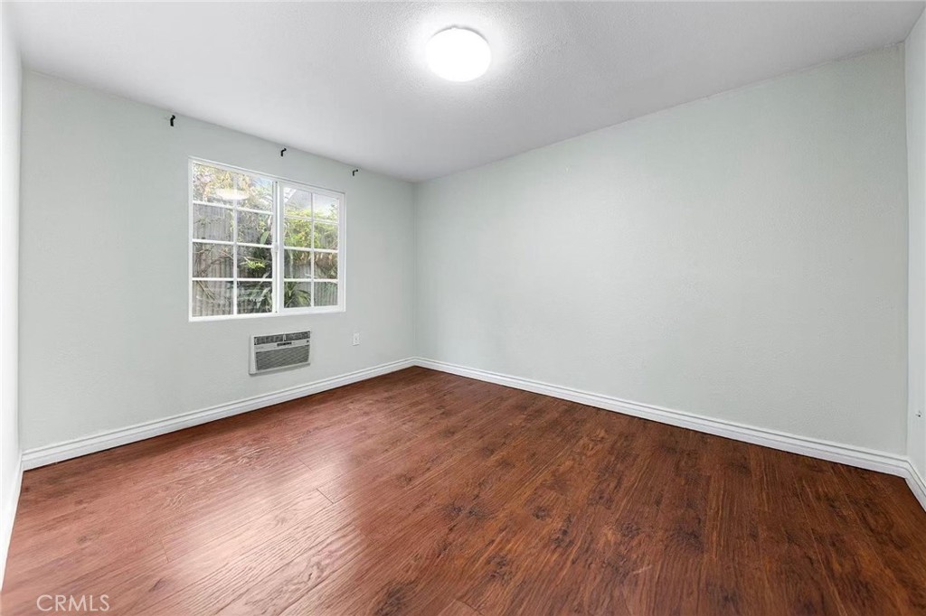 511 Dalesford Drive La Puente, CA 91744 - Photo 23 of 37 an empty room with wooden floor and windows