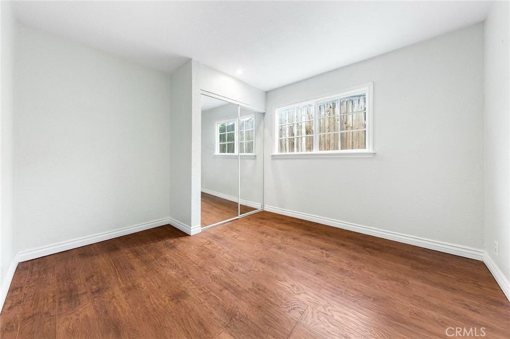 511 Dalesford Drive La Puente, CA 91744 - Photo 27 of 37 an empty room with wooden floor and windows