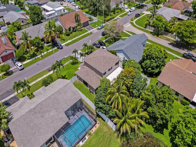 a kitchen with stainless steel appliances a dining table and chairs