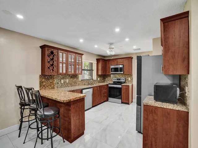 a kitchen with stainless steel appliances granite countertop a stove and a sink