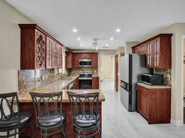 an aerial view of a house with garden space and street view
