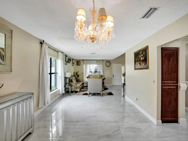 an aerial view of a house with a yard and table and chairs