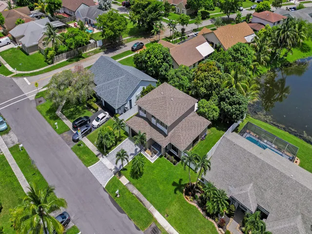 an aerial view of a house with garden space and lake view