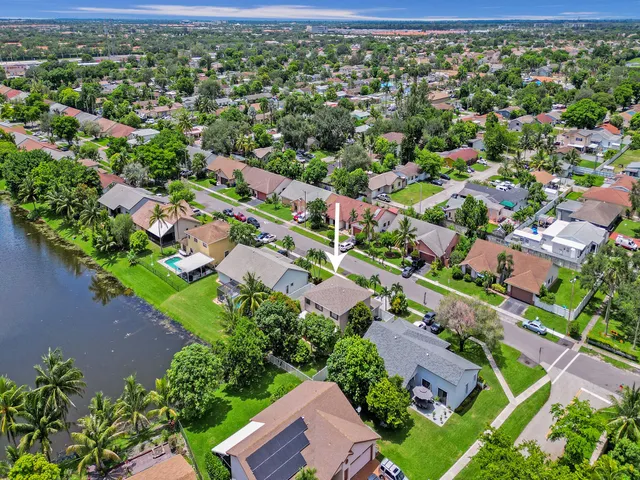 an aerial view of residential houses with outdoor space and street view