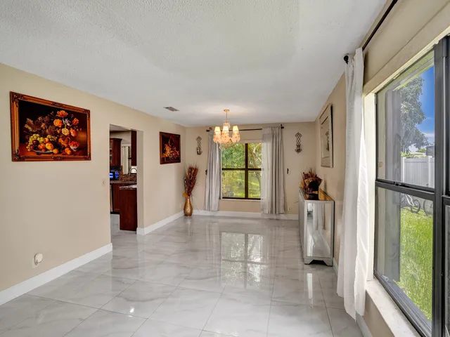 a living room with furniture flowerpot and wooden floor