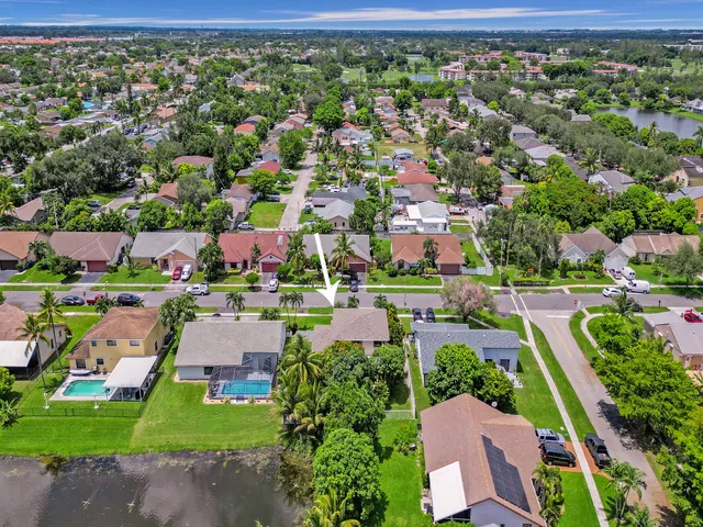 an aerial view of residential houses with outdoor space and street view