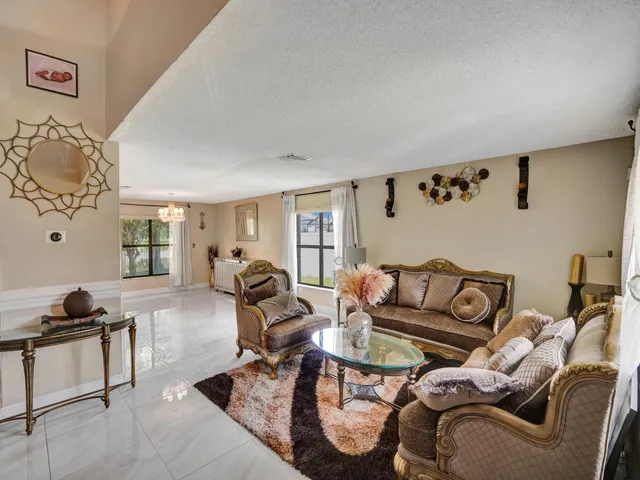 a living room with furniture tv and a large window