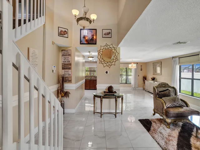 a living room with furniture kitchen view and a window