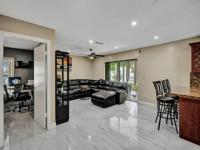 a bedroom with a large bed and wooden floor