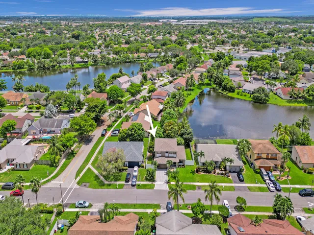 an aerial view of a house with a yard and a garden