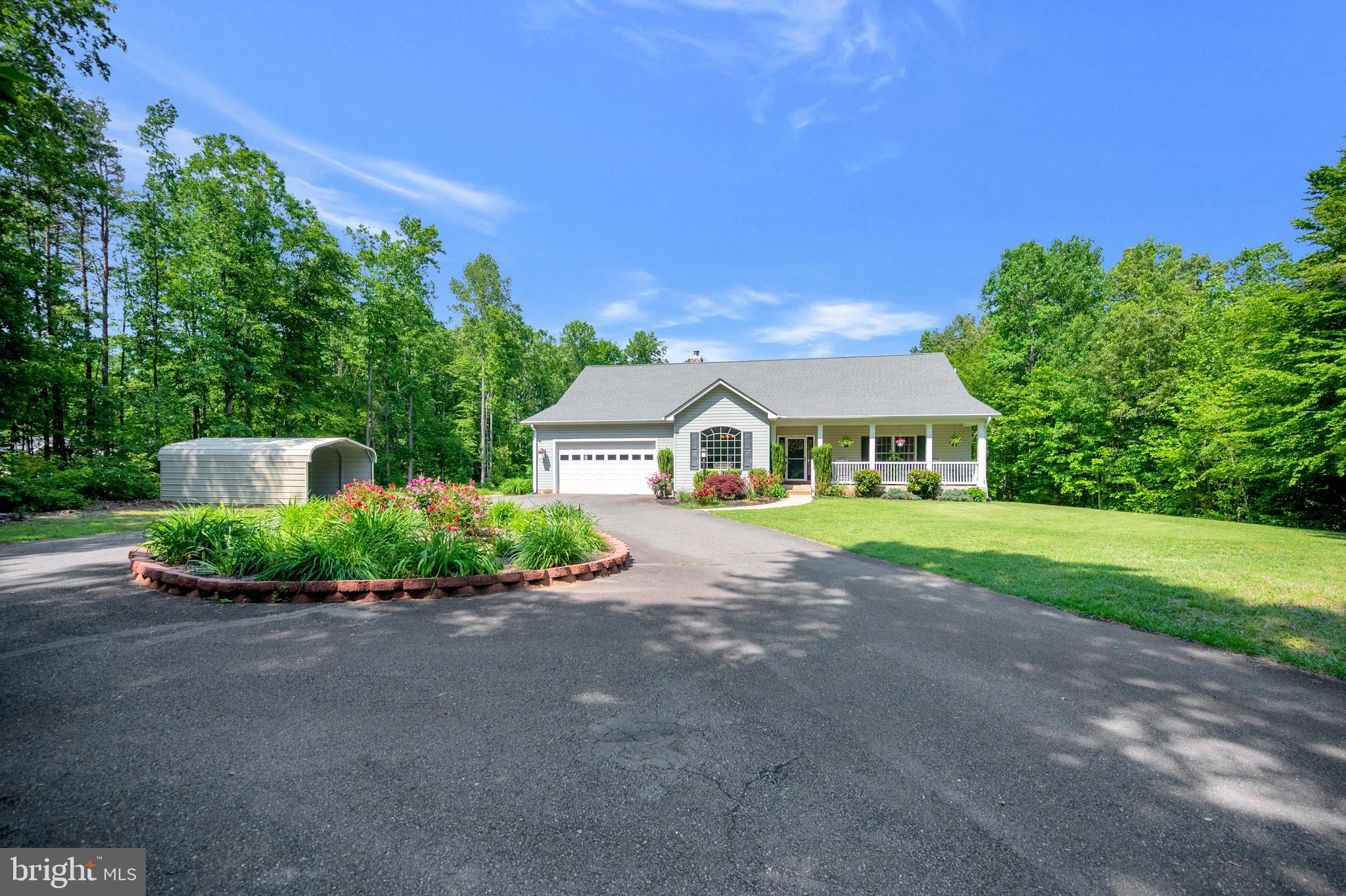 28229 Beech Drive Rhoadesville, VA 22542 - Photo 48 of 62 a front view of a house with a garden and deck