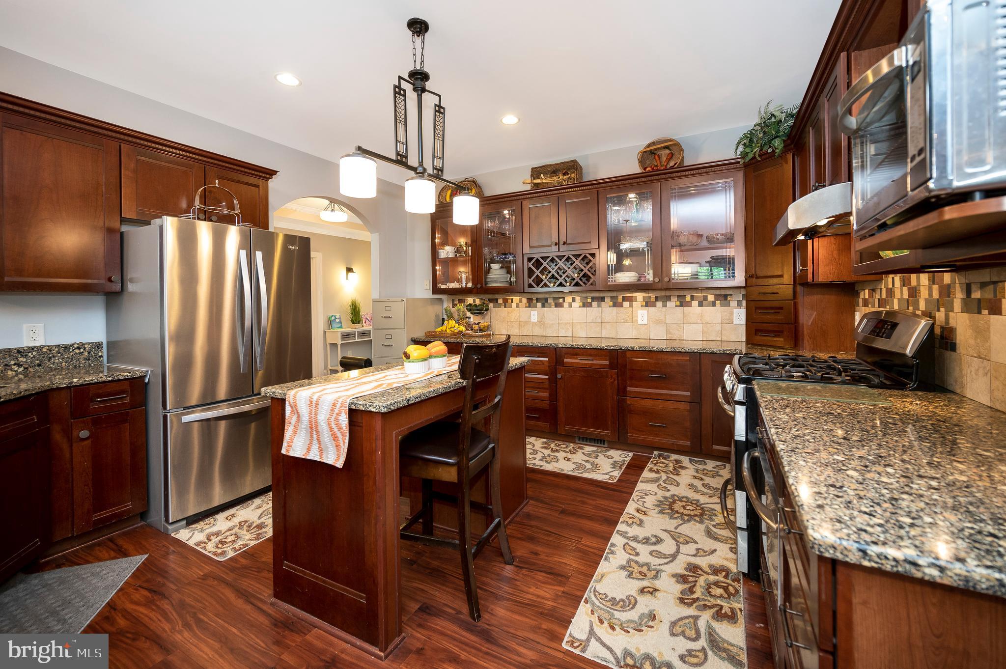28229 Beech Drive Rhoadesville, VA 22542 - Photo 8 of 62 a kitchen with stainless steel appliances granite countertop a table chairs and a refrigerator