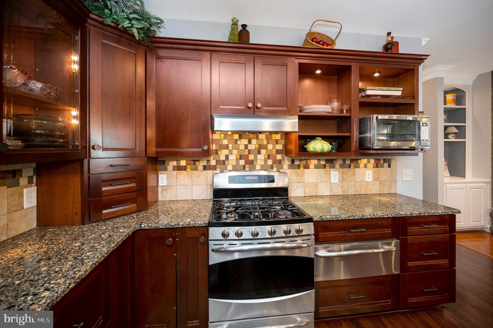 28229 Beech Drive Rhoadesville, VA 22542 - Photo 10 of 62 a kitchen with granite countertop stainless steel appliances and wooden cabinets