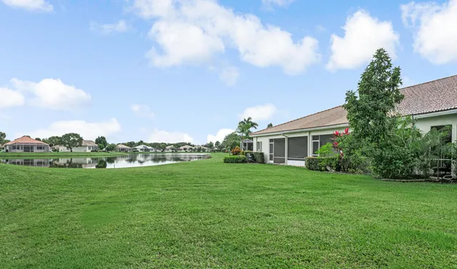 a front view of a house with a garden and trees