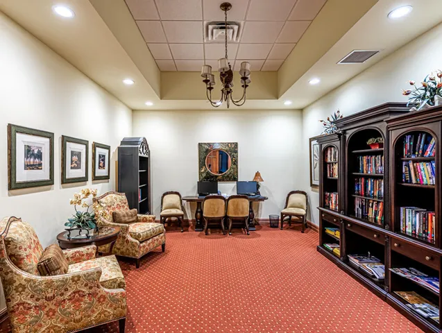 a large room with lots of tables a large window and chairs