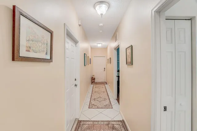 a view of a dining room with furniture and a chandelier