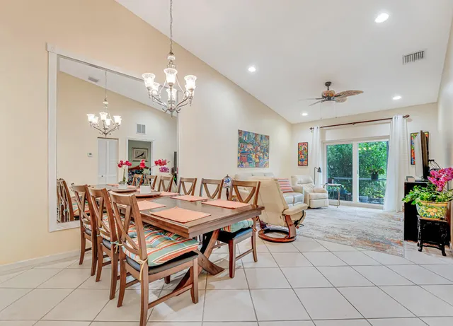 a view of a dining room with furniture and a chandelier