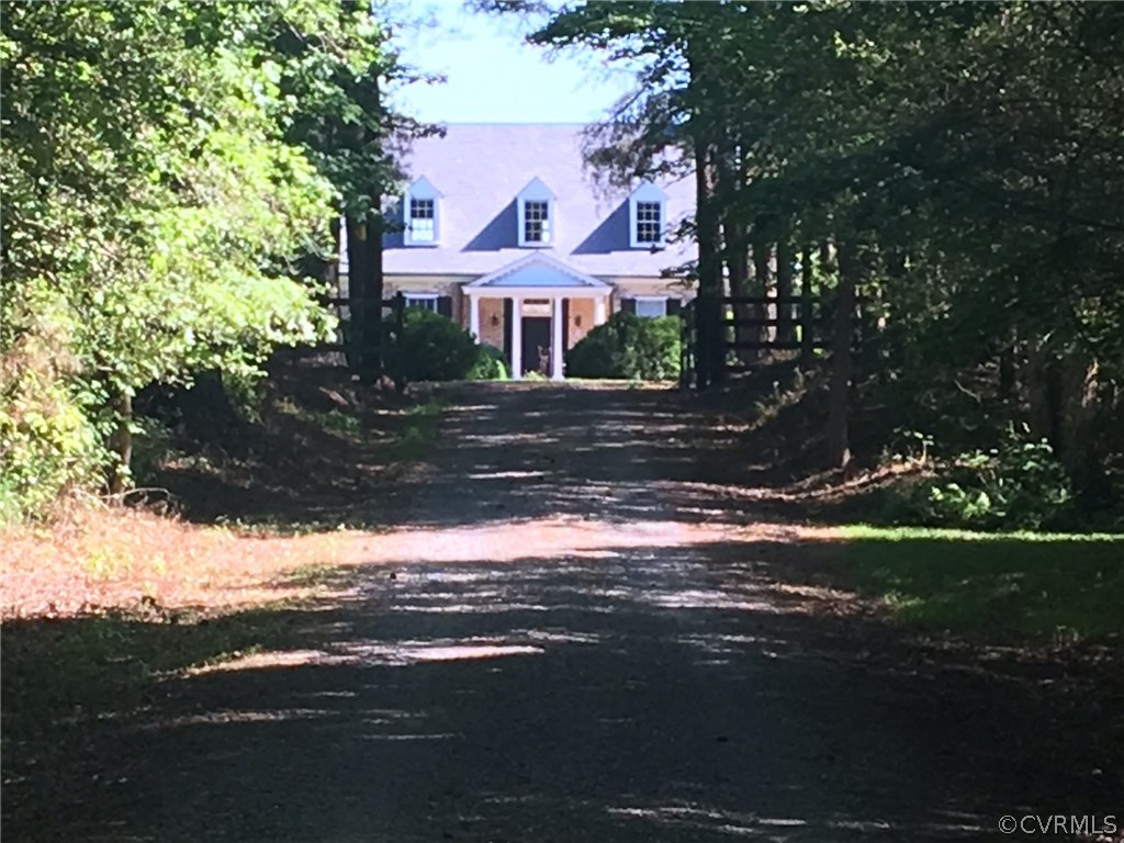 Long driveway winds through the woods as you appro