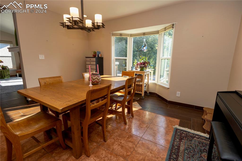 3123 Broadmoor Valley Road, Unit D Colorado Springs, CO 80906 - Photo 13 of 38 a view of a dining room with furniture window and outside view