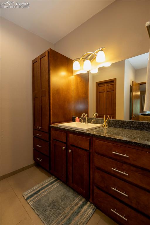 3123 Broadmoor Valley Road, Unit D Colorado Springs, CO 80906 - Photo 16 of 38 a bathroom with a sink and a mirror