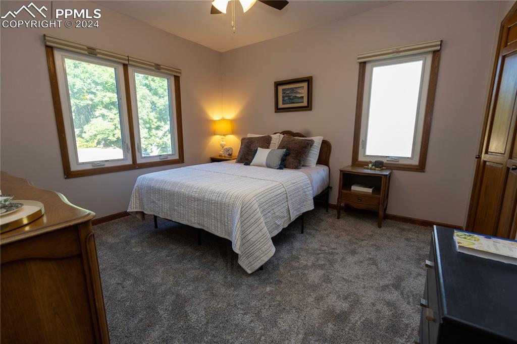 3123 Broadmoor Valley Road, Unit D Colorado Springs, CO 80906 - Photo 20 of 38 a bedroom with a bed and a window