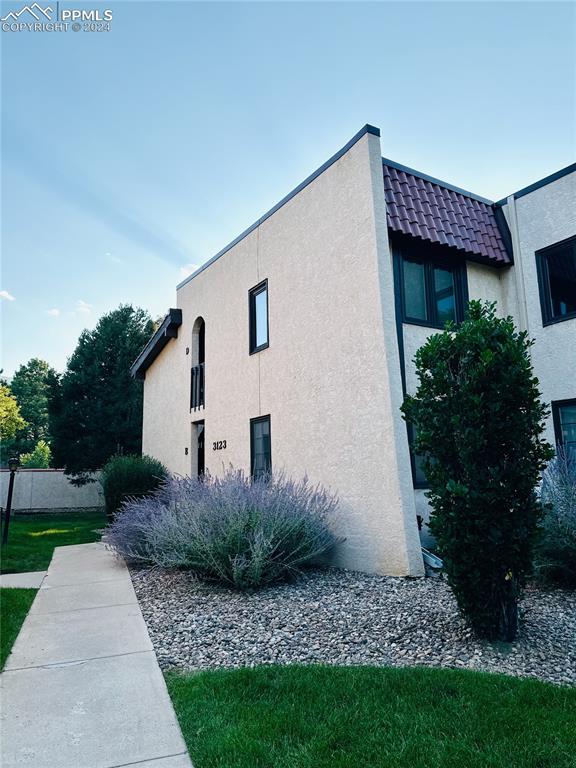 3123 Broadmoor Valley Road, Unit D Colorado Springs, CO 80906 - Photo 2 of 38 a view of a house with a yard
