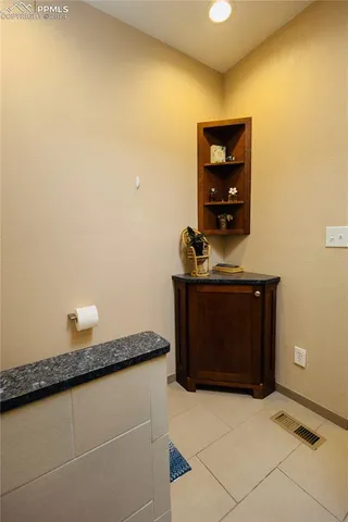 a view of a workspace with furniture and a ceiling fan