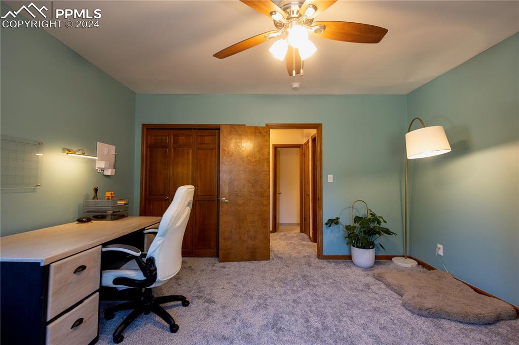 3123 Broadmoor Valley Road, Unit D Colorado Springs, CO 80906 - Photo 25 of 38 a view of a workspace with furniture and a ceiling fan