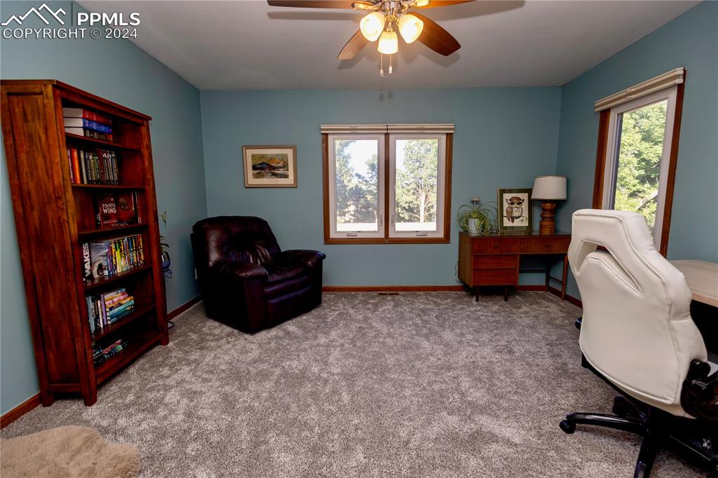 3123 Broadmoor Valley Road, Unit D Colorado Springs, CO 80906 - Photo 26 of 38 a living room with furniture and a window