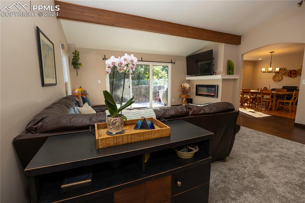 3123 Broadmoor Valley Road, Unit D Colorado Springs, CO 80906 - Photo 3 of 38 a living room with furniture a flat screen tv and a fireplace
