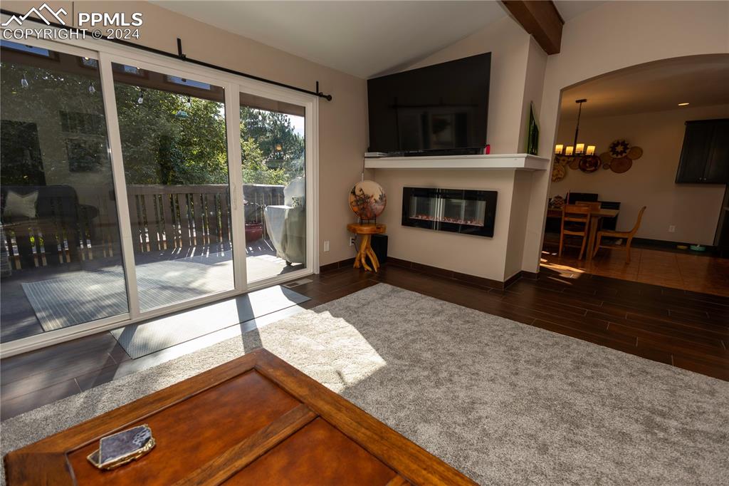 3123 Broadmoor Valley Road, Unit D Colorado Springs, CO 80906 - Photo 5 of 38 a living room with a large window and a fireplace