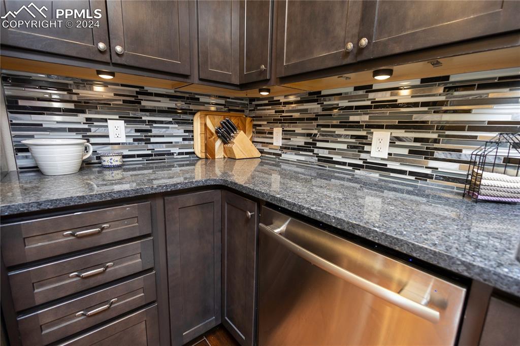 3123 Broadmoor Valley Road, Unit D Colorado Springs, CO 80906 - Photo 10 of 38 a kitchen with stainless steel appliances granite countertop a sink and a stove