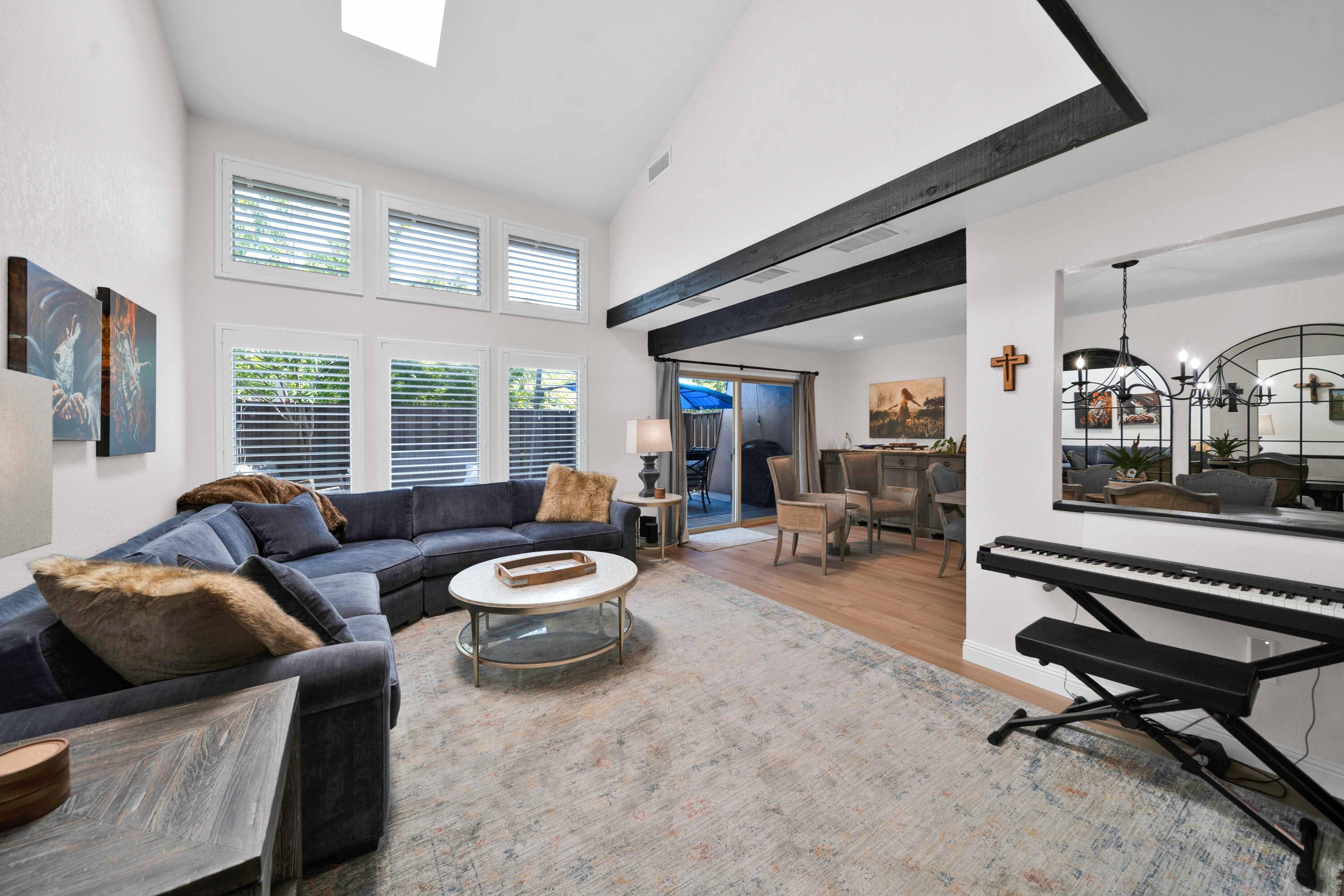 1928 Bechelli Lane Redding, CA 96002 - Photo 1 of 67 a living room with furniture a flat screen tv and a large window