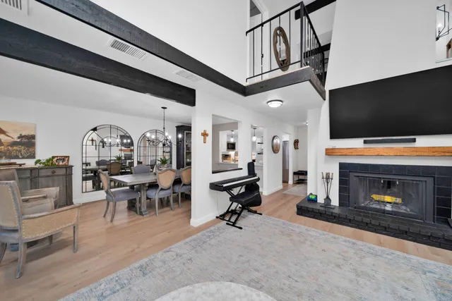 a living room with furniture a fireplace and a flat screen tv