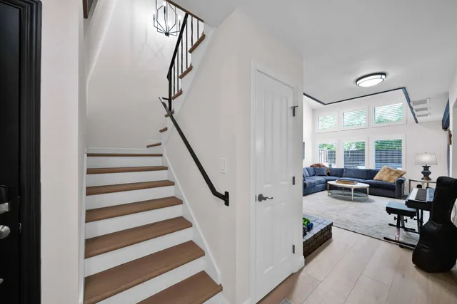 a spacious bedroom with a bed and ceiling fan