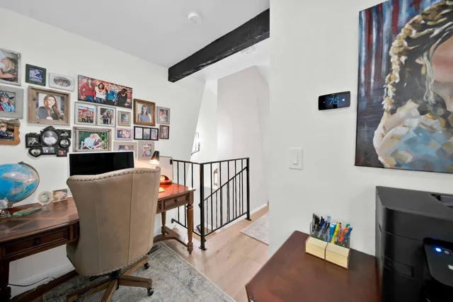 a view of a balcony with wooden floor & fence