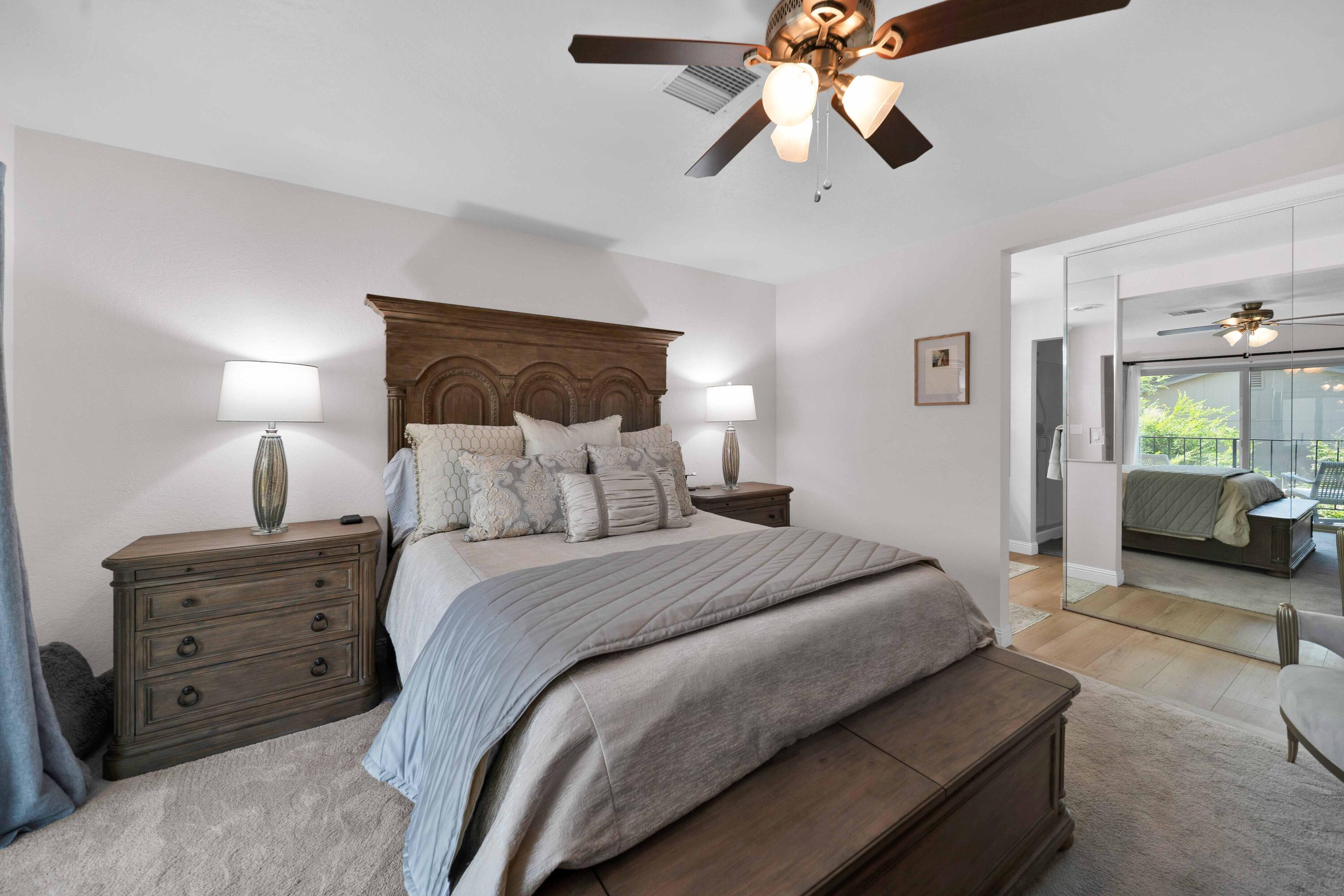 1928 Bechelli Lane Redding, CA 96002 - Photo 27 of 67 a spacious bedroom with a bed and ceiling fan