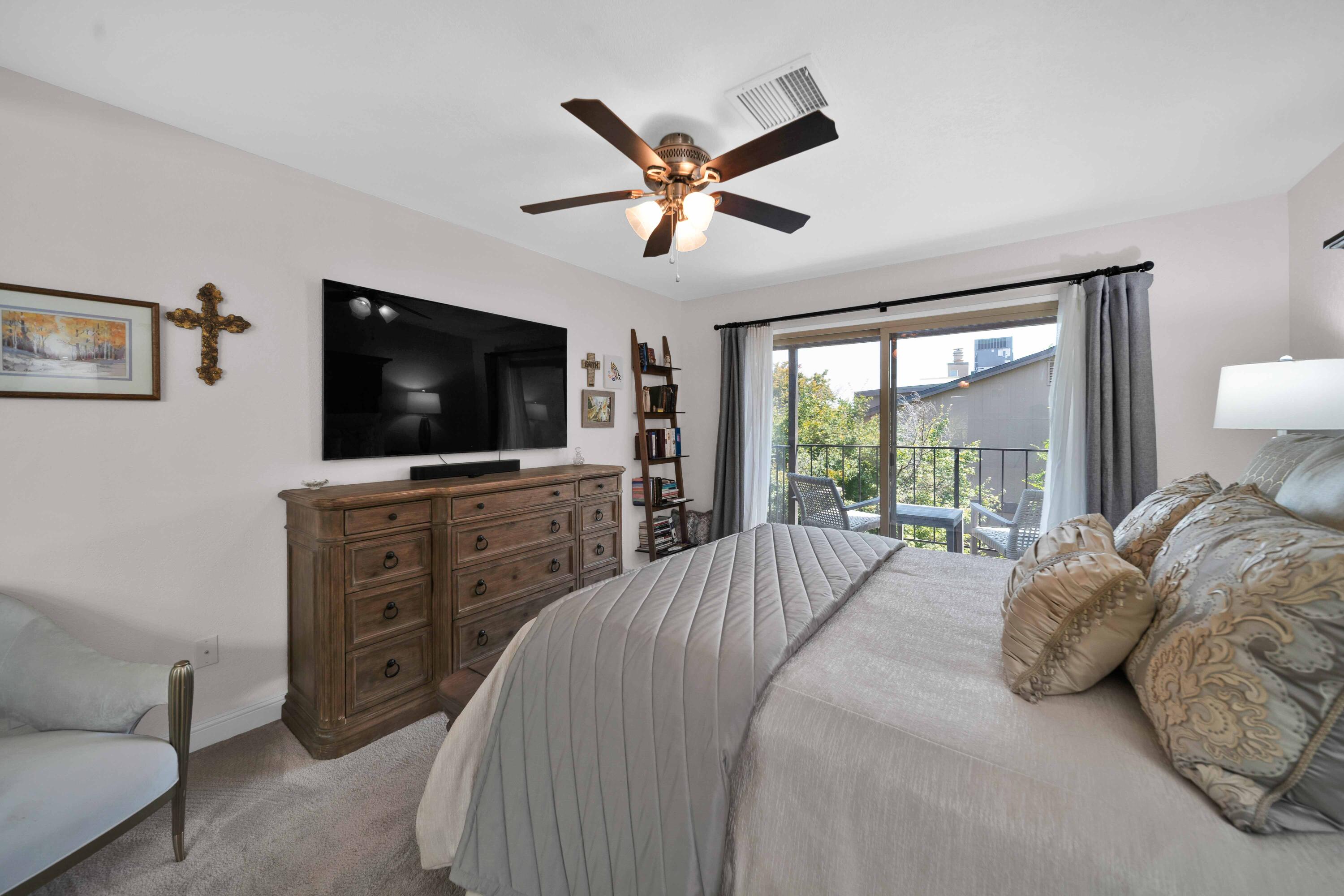 1928 Bechelli Lane Redding, CA 96002 - Photo 28 of 67 a bedroom with a bed and a flat screen tv