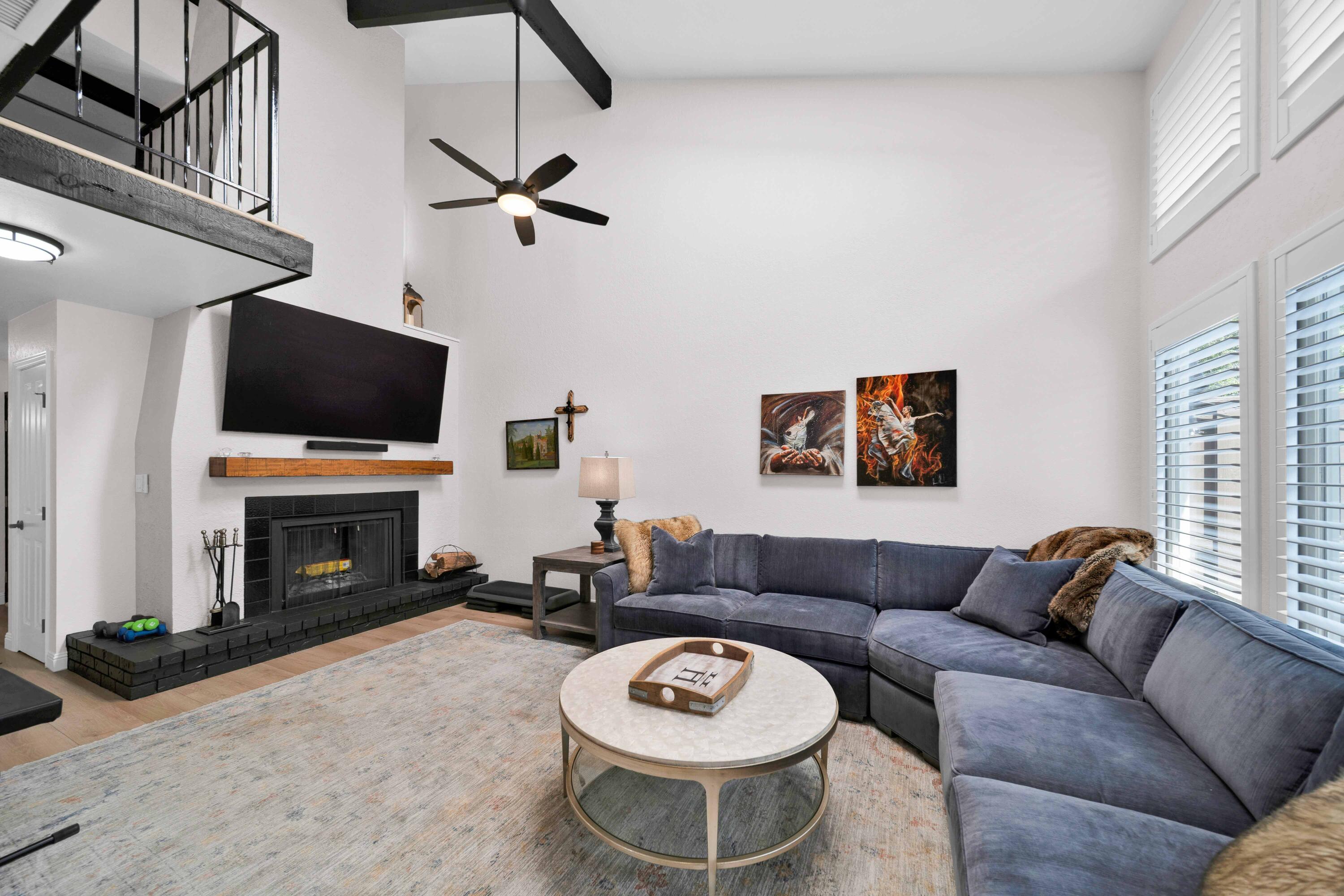 1928 Bechelli Lane Redding, CA 96002 - Photo 3 of 67 a living room with furniture a fireplace and a flat screen tv