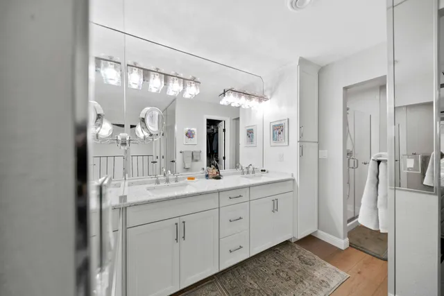 a bathroom with a sink toilet vanity and shower