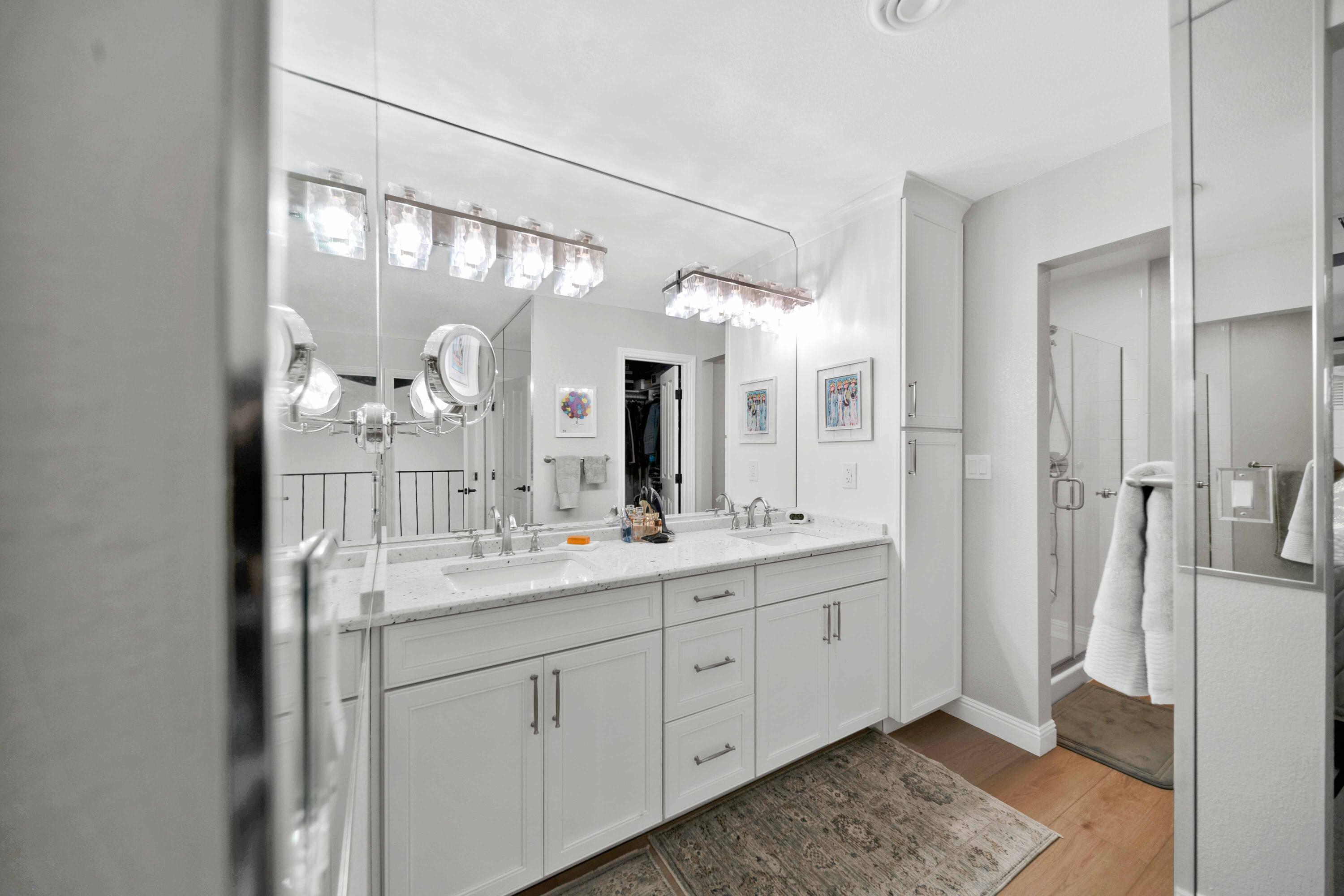 1928 Bechelli Lane Redding, CA 96002 - Photo 32 of 67 a bathroom with a double vanity sink and mirror